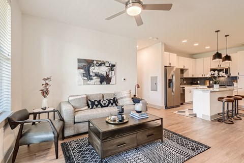 Open-concept living space with wood-designed flooring at Cypress McKinney Falls in Austin, TX